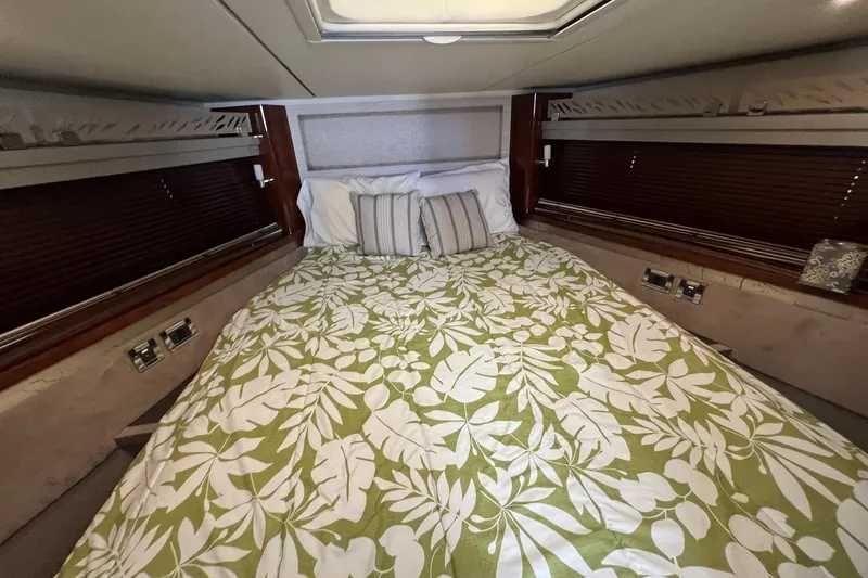 Slide: The Image of 2019 Sea Ray L550 boat interior with cushioned seating and storage compartments. - 32