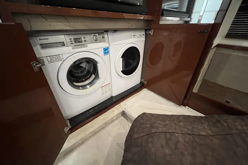 Slide: The Image of 2019 Sea Ray L550 yacht dashboard with Raymarine navigation display and controls. - 38