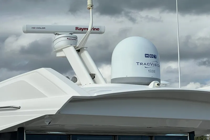 Slide: The Image of 2019 Sea Ray L550 yacht docked at a marina, front view. - 4