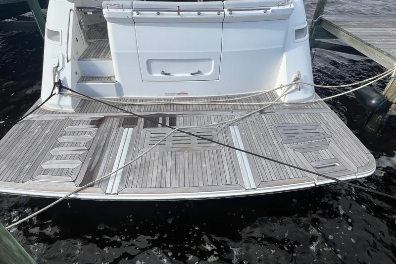 Slide: The Image of 2019 Sea Ray L550 yacht docked at marina with scenic waterfront view. - 5