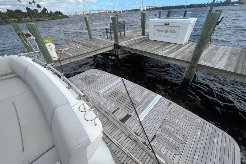 Slide: The Image of 2019 Sea Ray L550 yacht docked at marina under cloudy sky. - 6