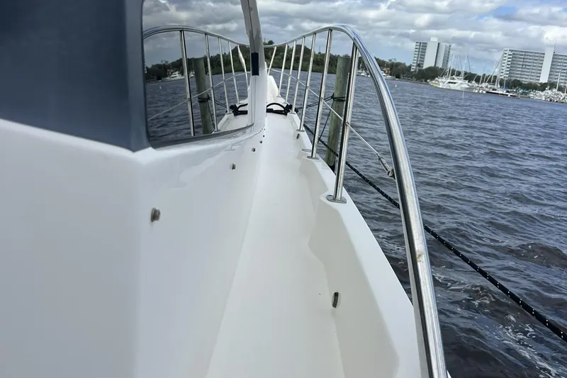 Slide: The Image of 2019 Sea Ray L550 yacht docked at marina under clear blue sky. - 8