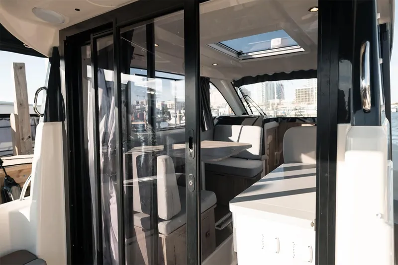 Slide: The Image of Manufacturer Provided Image: Interior view of 2025 Bayliner Trophy T29 Explorer boat with modern seating and glass doors. - 4