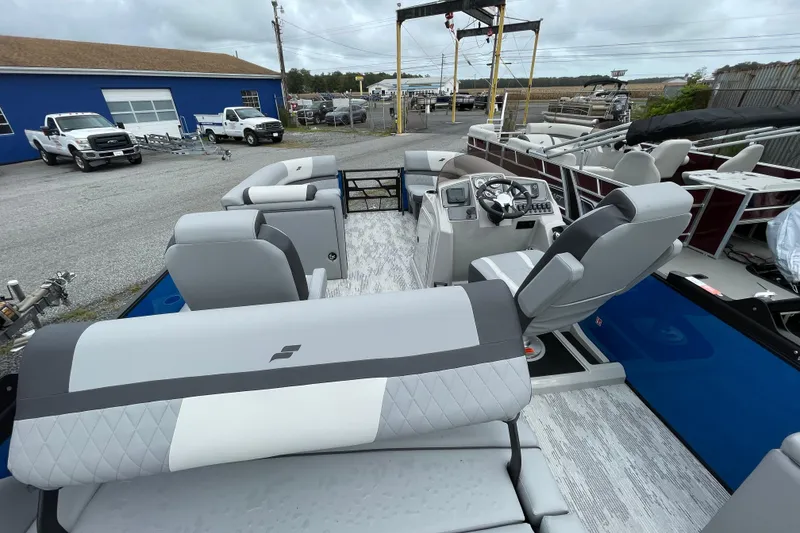 Slide: The Image of 2026 Starcraft EXS 3 DL pontoon boat interior with modern seating and control panel. - 10