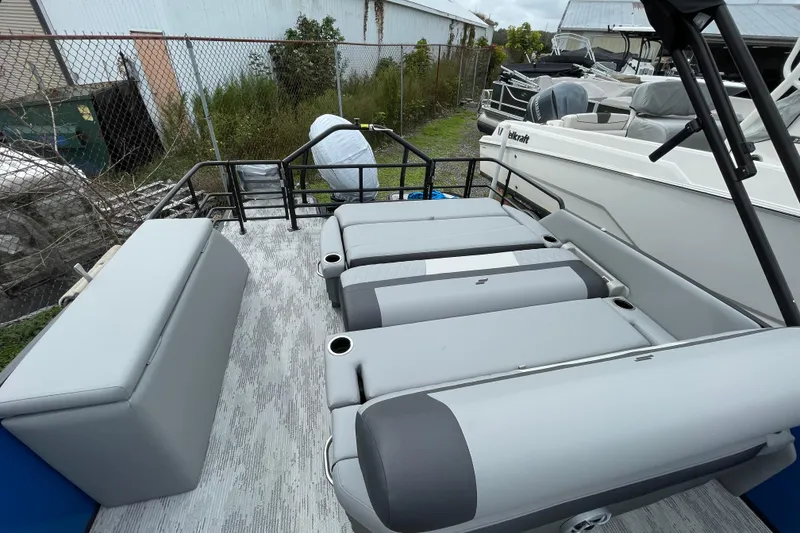 Slide: The Image of 2026 Starcraft EXS 3 DL pontoon boat interior with gray seating and cup holders. - 6