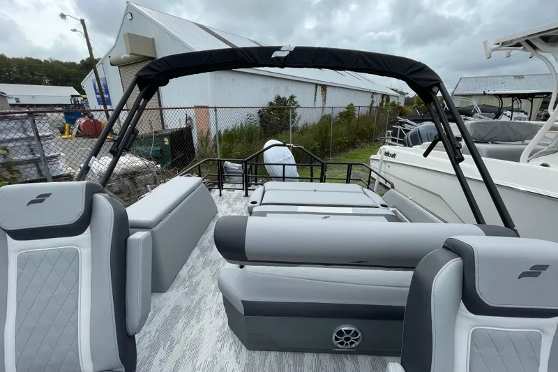 Slide: The Image of 2026 Starcraft EXS 3 DL pontoon boat with gray seating and black canopy. - 7