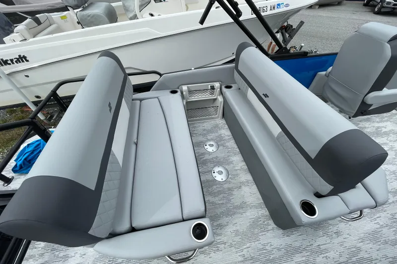Slide: The Image of 2026 Starcraft EXS 3 DL boat interior with gray seating and cup holders. - 8