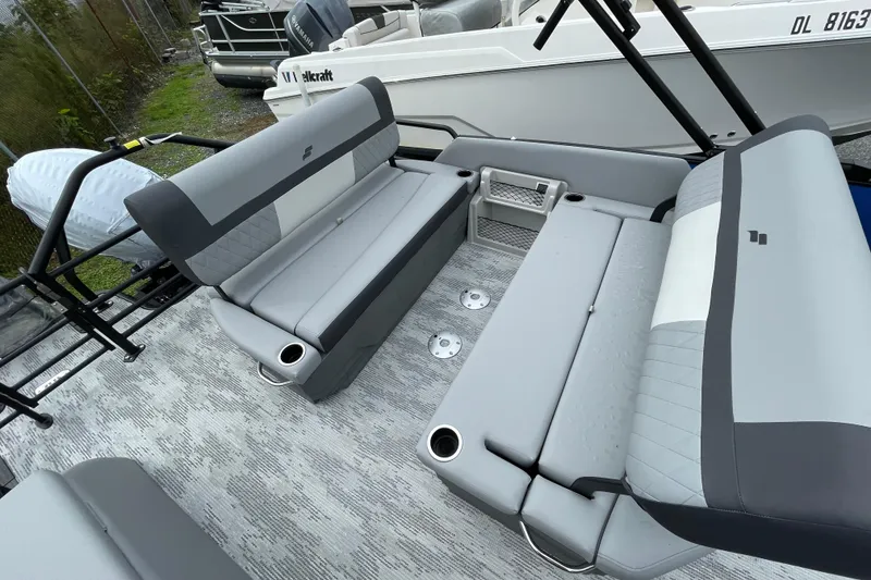 Slide: The Image of 2026 Starcraft EXS 3 DL boat interior with gray seating and cup holders. - 9