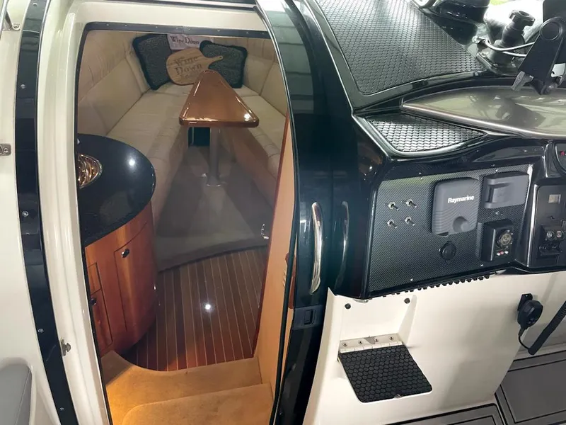Slide: The Image of Interior of a 2005 Cobalt 360 boat, featuring a cozy cabin and modern dashboard. - 13