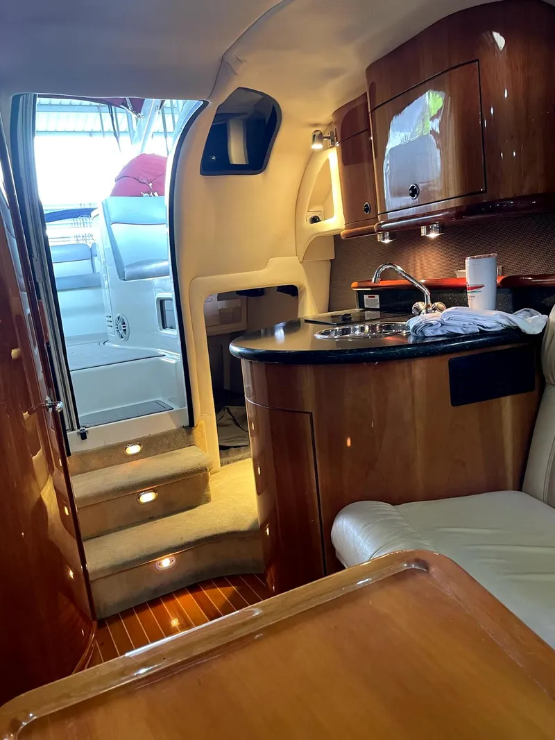 Slide: The Image of Luxurious interior of a 2005 Cobalt 360 yacht with wood finishes and kitchenette. - 14