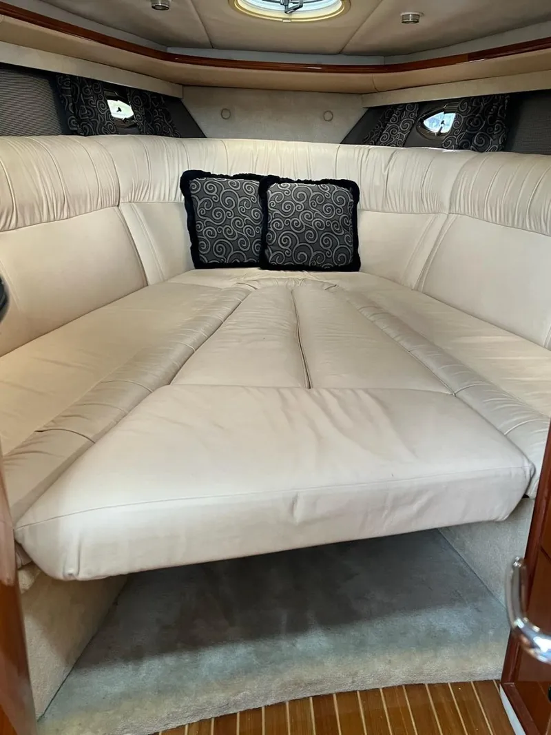 Slide: The Image of Luxurious interior cabin of a 2005 Cobalt 360 boat with plush bedding. - 16