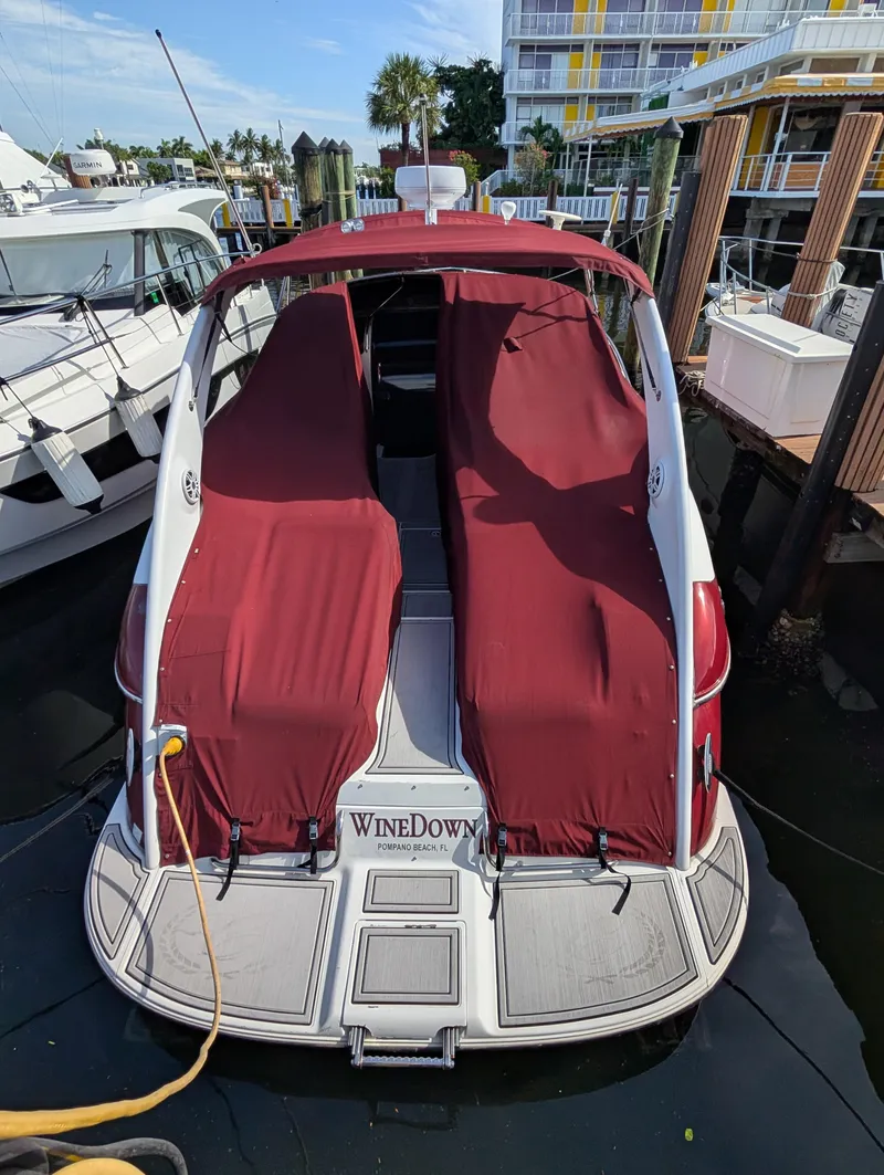 Slide: The Image of 2005 Cobalt 360 boat with red covers docked at marina. - 4