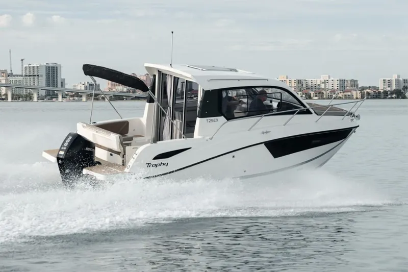 The Image of Manufacturer Provided Image: 2025 Bayliner Trophy T25 Explorer cruising on water, cityscape in background. - 0