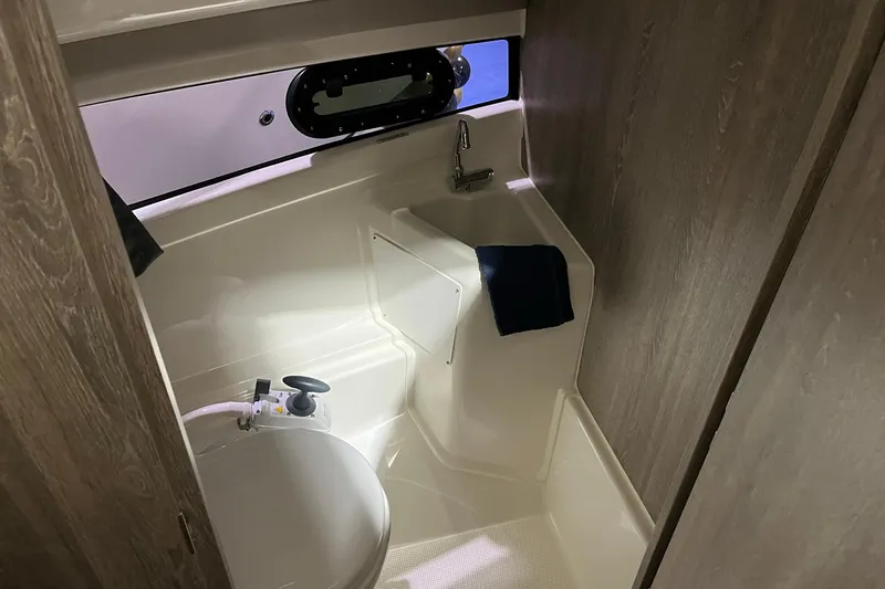 Slide: The Image of 2026 Bayliner Trophy T25 Explorer boat bathroom with compact design and modern fixtures. - 11
