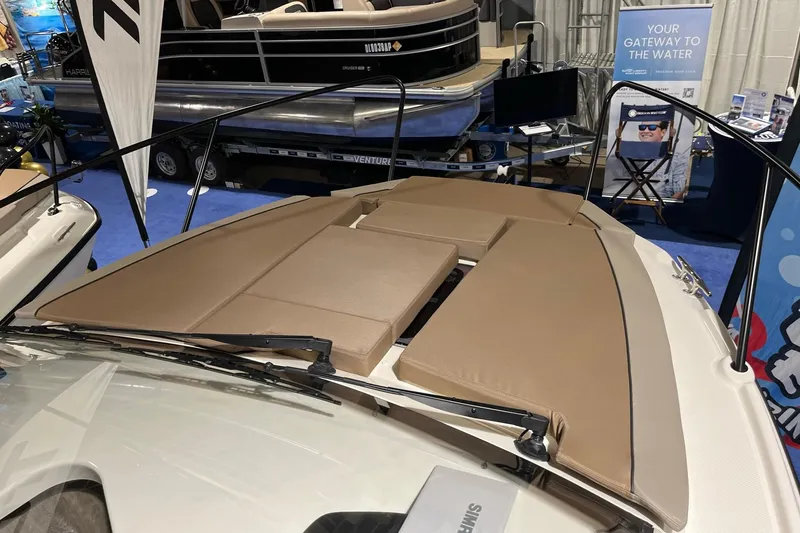 Slide: The Image of 2026 Bayliner Trophy T25 Explorer boat with cushioned deck at a boat show. - 12
