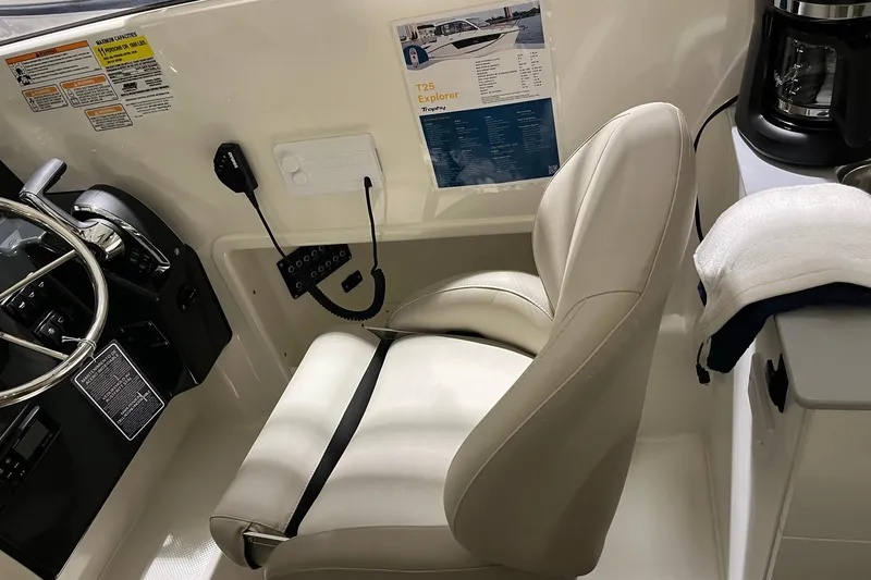 Slide: The Image of Captain's seat and helm of 2026 Bayliner Trophy T25 Explorer boat interior. - 9