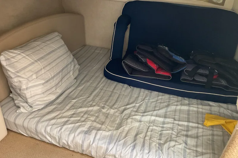 Slide: The Image of Interior cabin of 2003 Bayliner 3055 Ciera with bed and life jackets. - 11