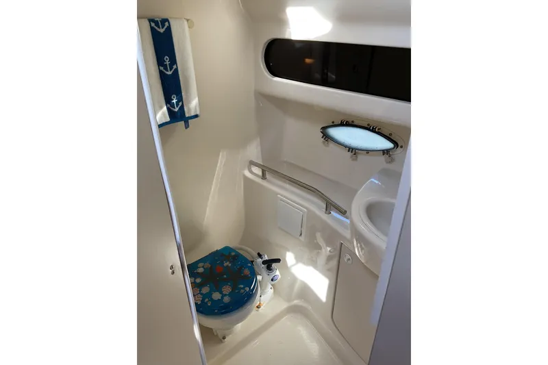 Slide: The Image of 2003 Bayliner 3055 Ciera bathroom with nautical decor and compact design. - 12