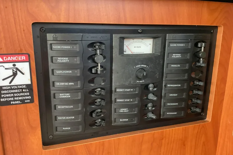 Slide: The Image of Electrical panel on a 2003 Bayliner 3055 Ciera boat with various switches and warning sign. - 13