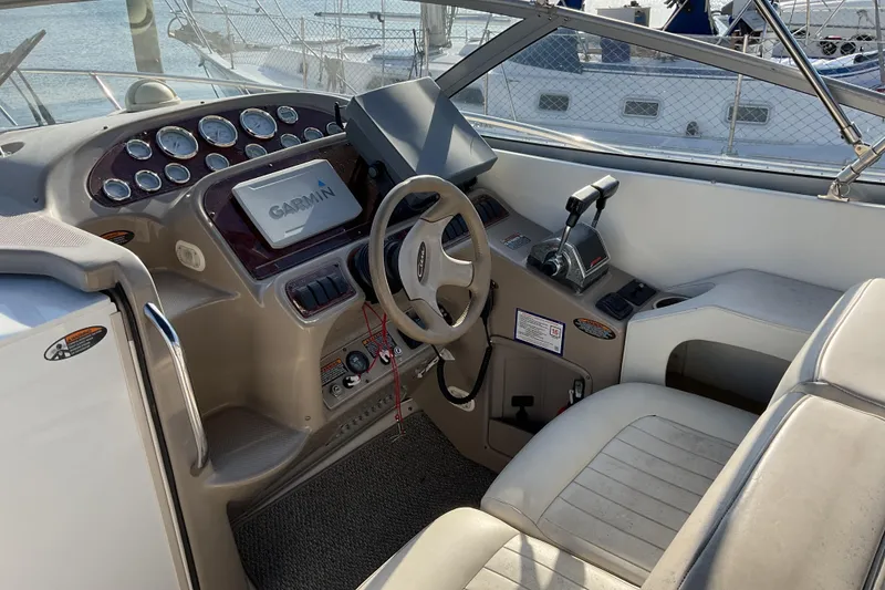 Slide: The Image of 2003 Bayliner 3055 Ciera cockpit with Garmin navigation system and steering wheel. - 3