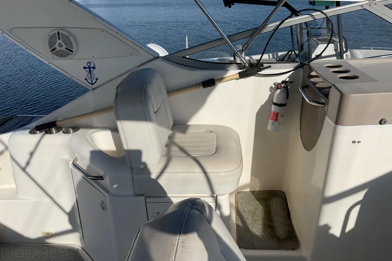 Slide: The Image of 2003 Bayliner 3055 Ciera cockpit with seating, fire extinguisher, and cup holders. - 5
