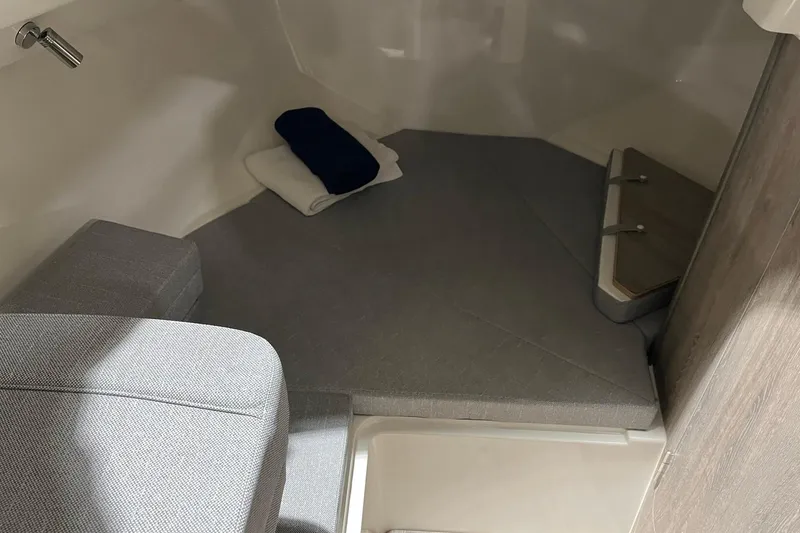 Slide: The Image of Interior cabin of 2026 Bayliner Trophy T23 Explorer with cushions and folded towels. - 12