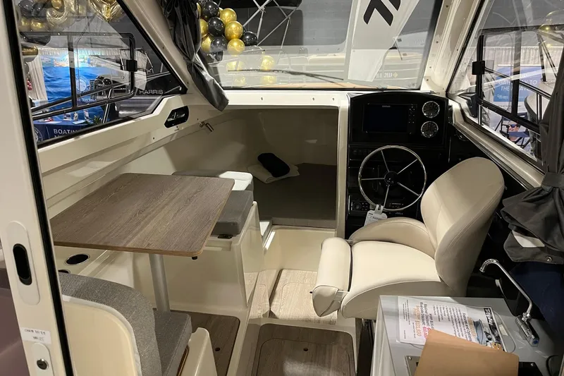 Slide: The Image of Interior of 2026 Bayliner Trophy T23 Explorer boat with seating and steering wheel. - 7