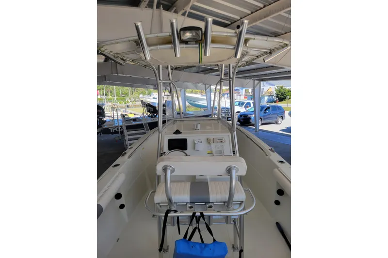 Slide: The Image of 2006 Sailfish 218 CC boat interior with console and seating under a canopy. - 3