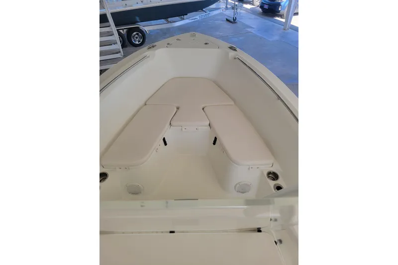 Slide: The Image of 2006 Sailfish 218 CC boat interior with cushioned seating in a showroom. - 4