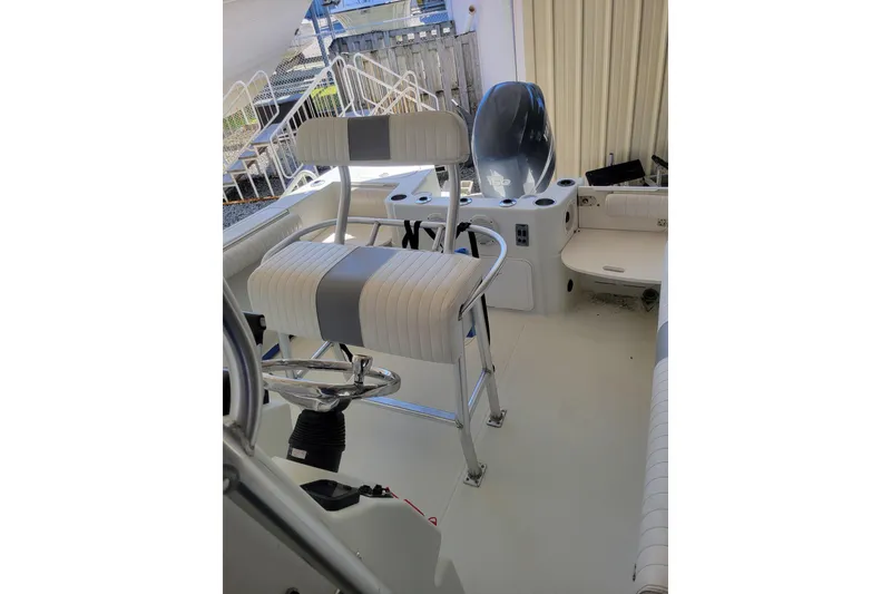 Slide: The Image of 2006 Sailfish 218 CC boat interior with steering wheel and seating. - 6