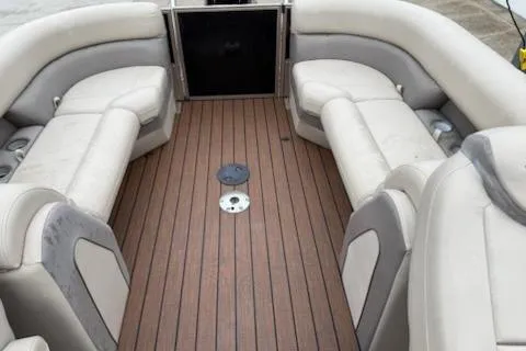 Slide: The Image of 2021 Bentley Pontoons 220 Elite Admiral interior with plush seating and wood-style flooring. - 7