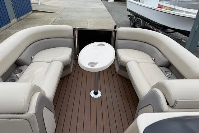 Slide: The Image of 2021 Bentley Pontoons 220 Elite Admiral interior with beige seating and round table. - 8