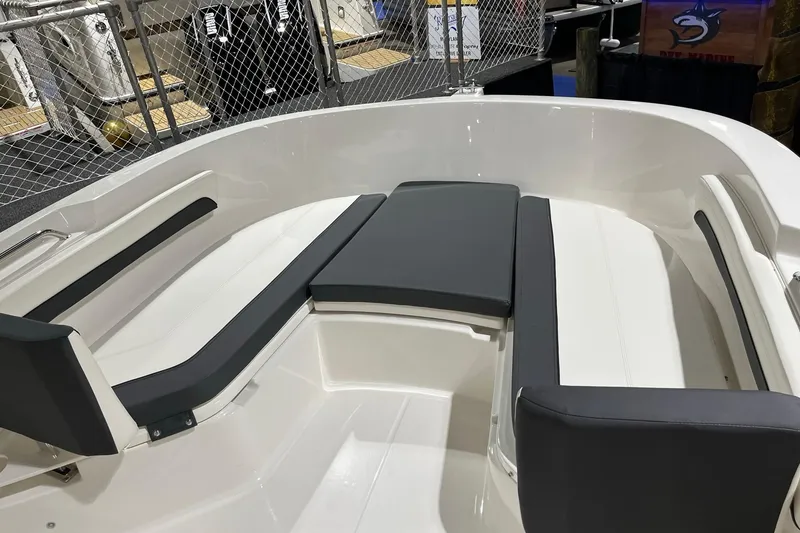 Slide: The Image of 2026 Bayliner Trophy T22CC boat interior with cushioned seating and sleek design. - 12