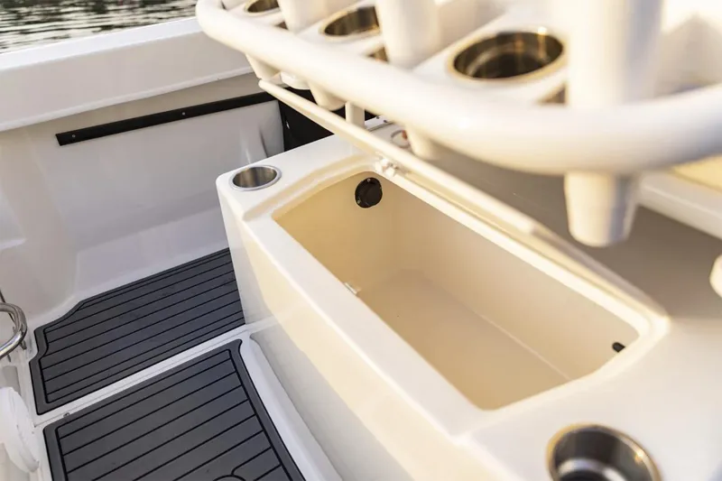 Slide: The Image of Manufacturer Provided Image: 2025 Bayliner Trophy T22CC boat interior with rod holders and storage compartment. - 7