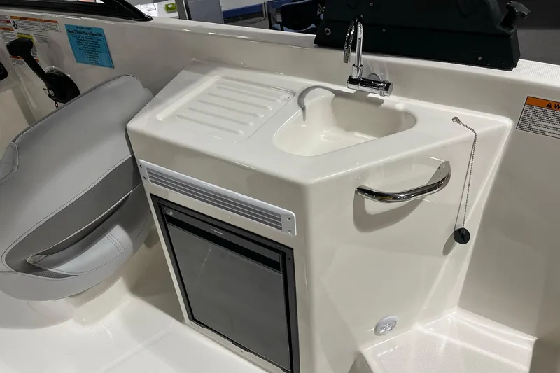 Slide: The Image of 2026 Bayliner D22 boat interior with sink and mini fridge. - 10