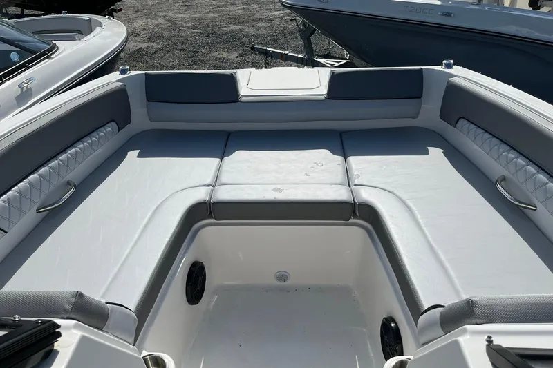 Slide: The Image of 2026 Bayliner D22 boat interior with cushioned seating and storage compartments. - 15