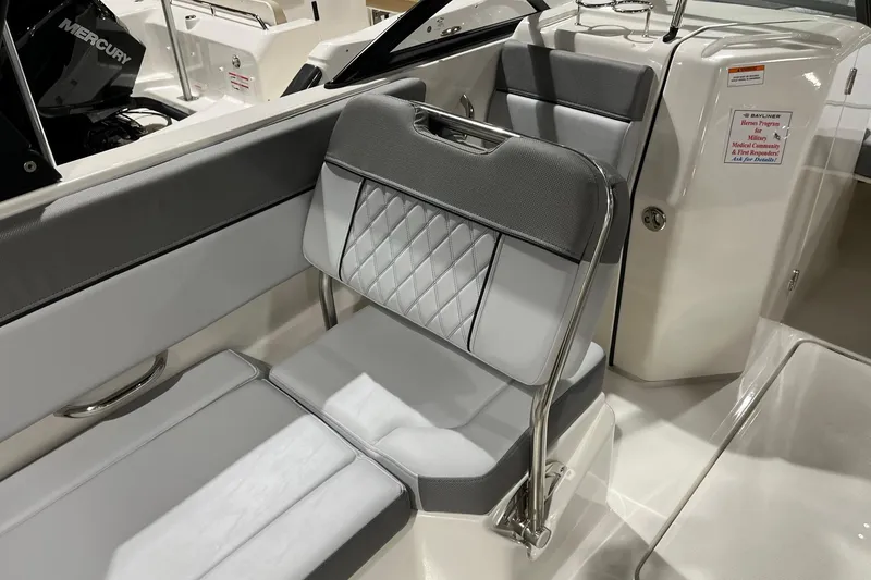 Slide: The Image of 2026 Bayliner D22 boat interior with gray and white seating, featuring a Mercury engine. - 8