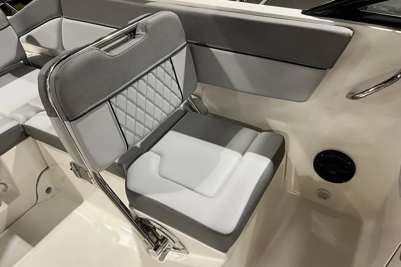 Slide: The Image of 2026 Bayliner D22 boat interior with gray and white cushioned seating. - 9
