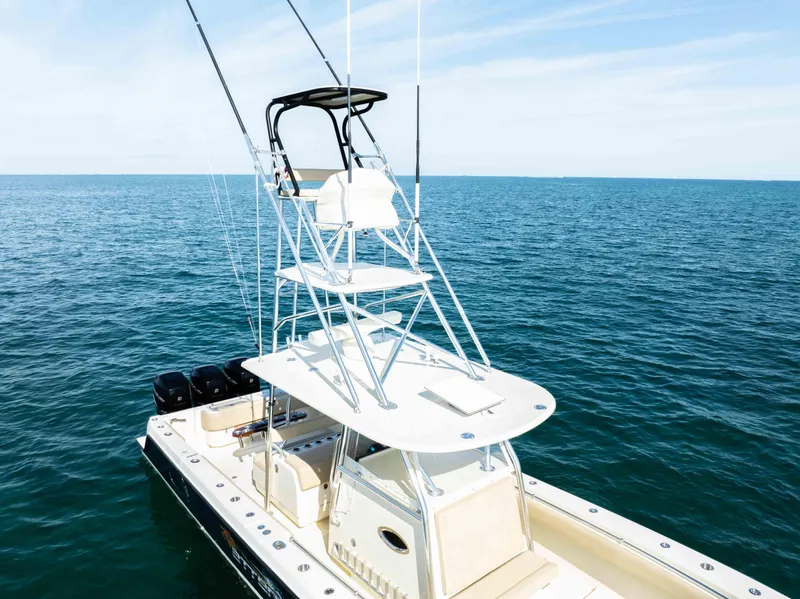 Slide: The Image of 2012 Contender 39 ST boat on open sea with fishing tower and multiple outboard engines. - 13