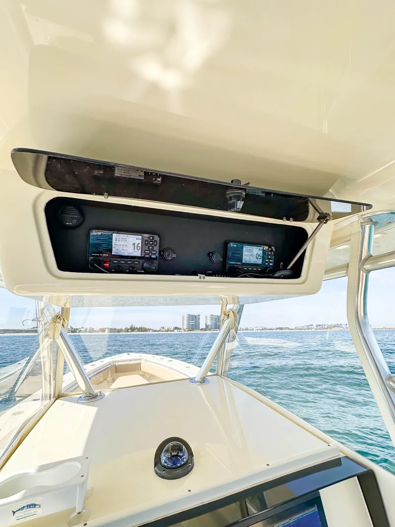 Slide: The Image of 2012 Contender 39 ST boat dashboard with navigation equipment on open water. - 14