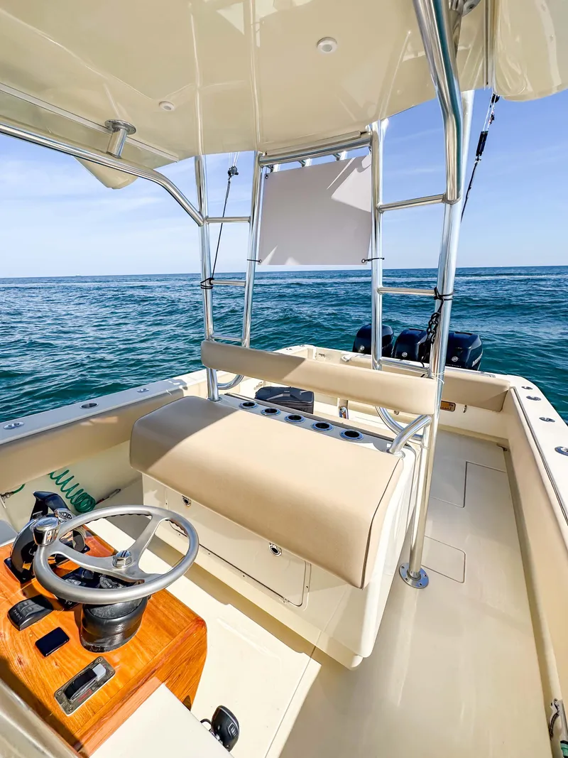 Slide: The Image of 2012 Contender 39 ST boat interior with ocean view, featuring helm and seating area. - 18