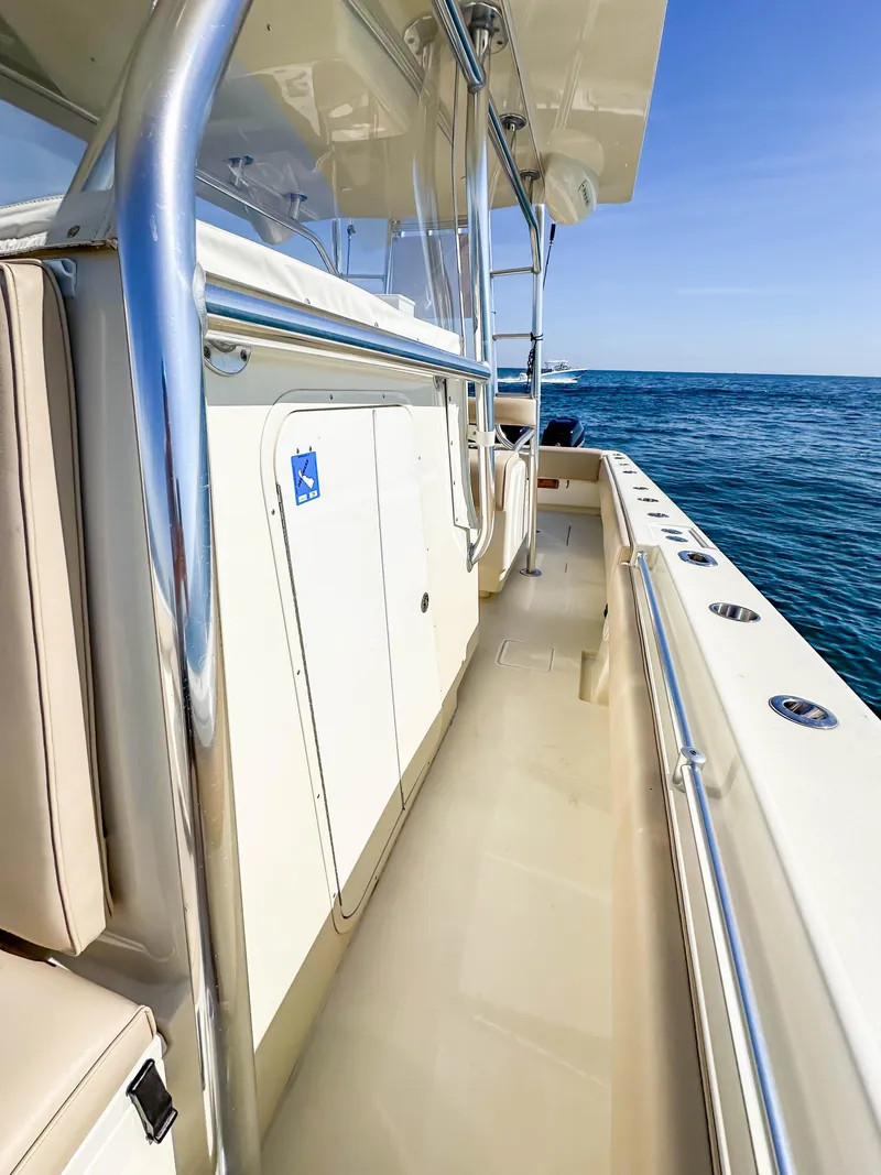 Slide: The Image of 2012 Contender 39 ST boat deck with ocean view, featuring sleek design and stainless steel railings. - 19
