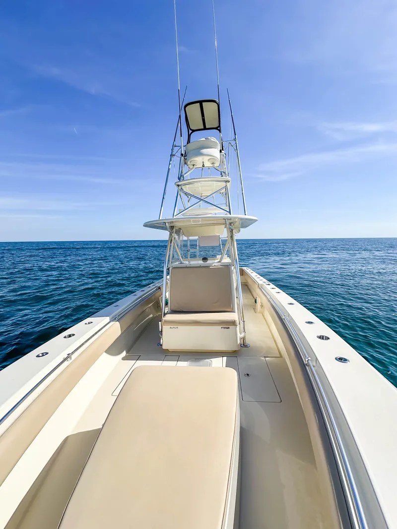 Slide: The Image of 2012 Contender 39 ST boat on open sea under clear blue sky. - 21