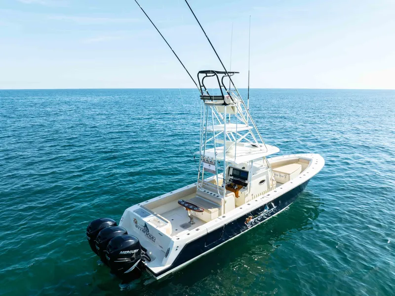 Slide: The Image of 2012 Contender 39 ST boat on open sea with triple outboard engines. - 4