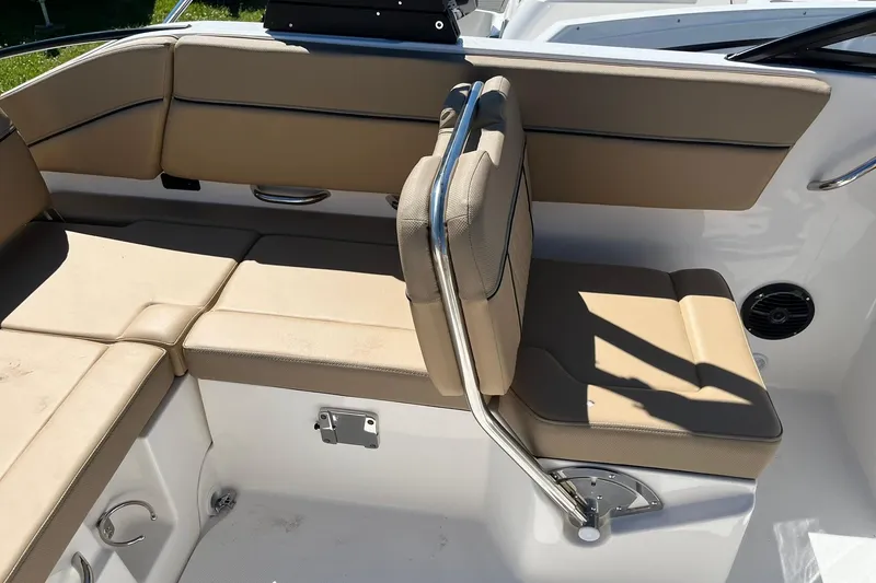 Slide: The Image of 2026 Bayliner D22 boat interior with beige seating and stainless steel accents. - 10