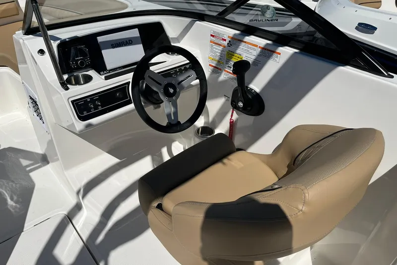 Slide: The Image of 2026 Bayliner D22 boat cockpit with steering wheel and control panel. - 13