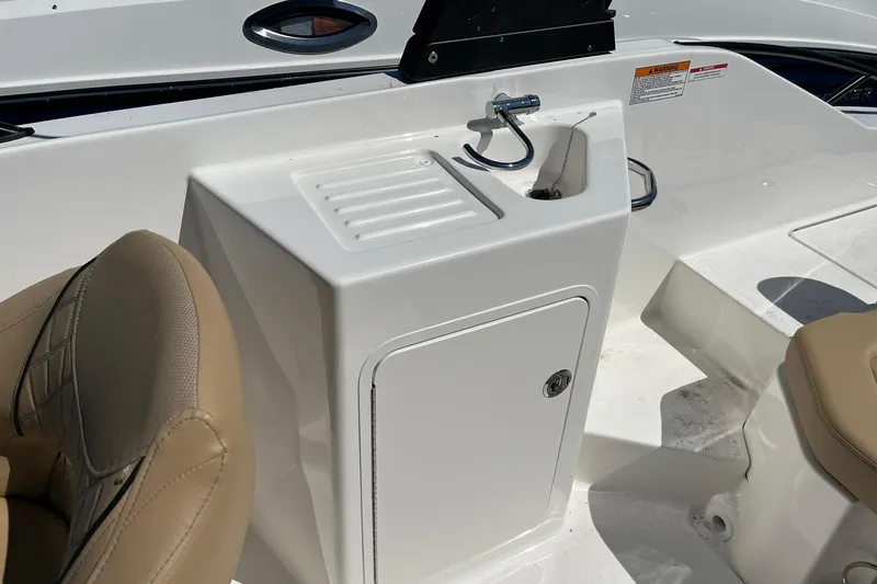 Slide: The Image of 2026 Bayliner D22 boat interior with sink and beige seating. - 9