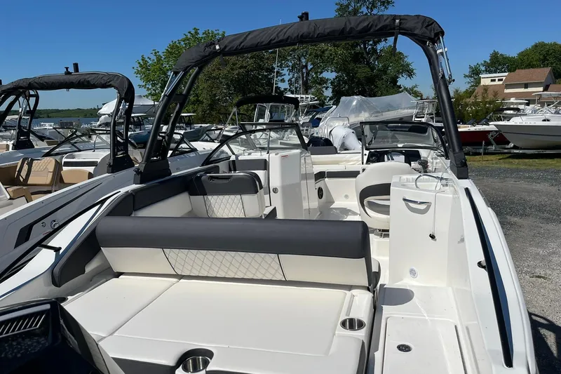Slide: The Image of 2026 Bayliner D22 boat with sleek seating and modern design at a marina. - 18