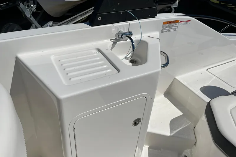 Slide: The Image of 2026 Bayliner D22 boat interior with sink and storage compartment. - 8