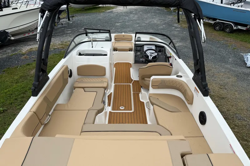 Slide: The Image of 2025 Bayliner VR6 Bowrider I/O on trailer, parked outdoors under cloudy sky. - 4